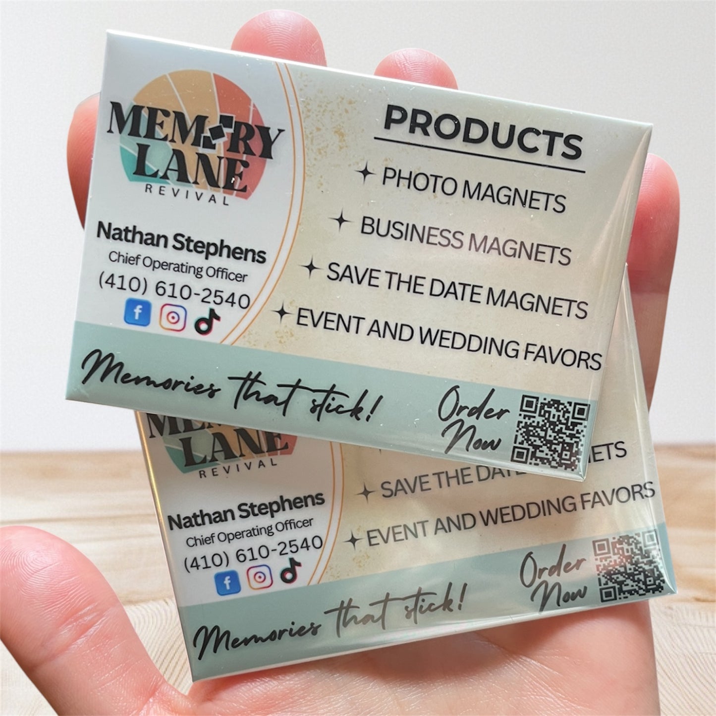 Hand holding a business card for Memory Lane Revival with product information.