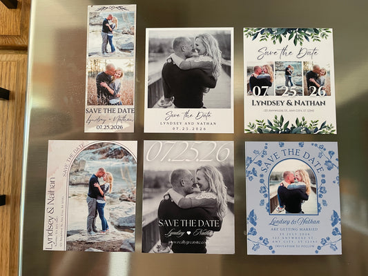 Collection of 'Save the Date' cards on a metallic surface